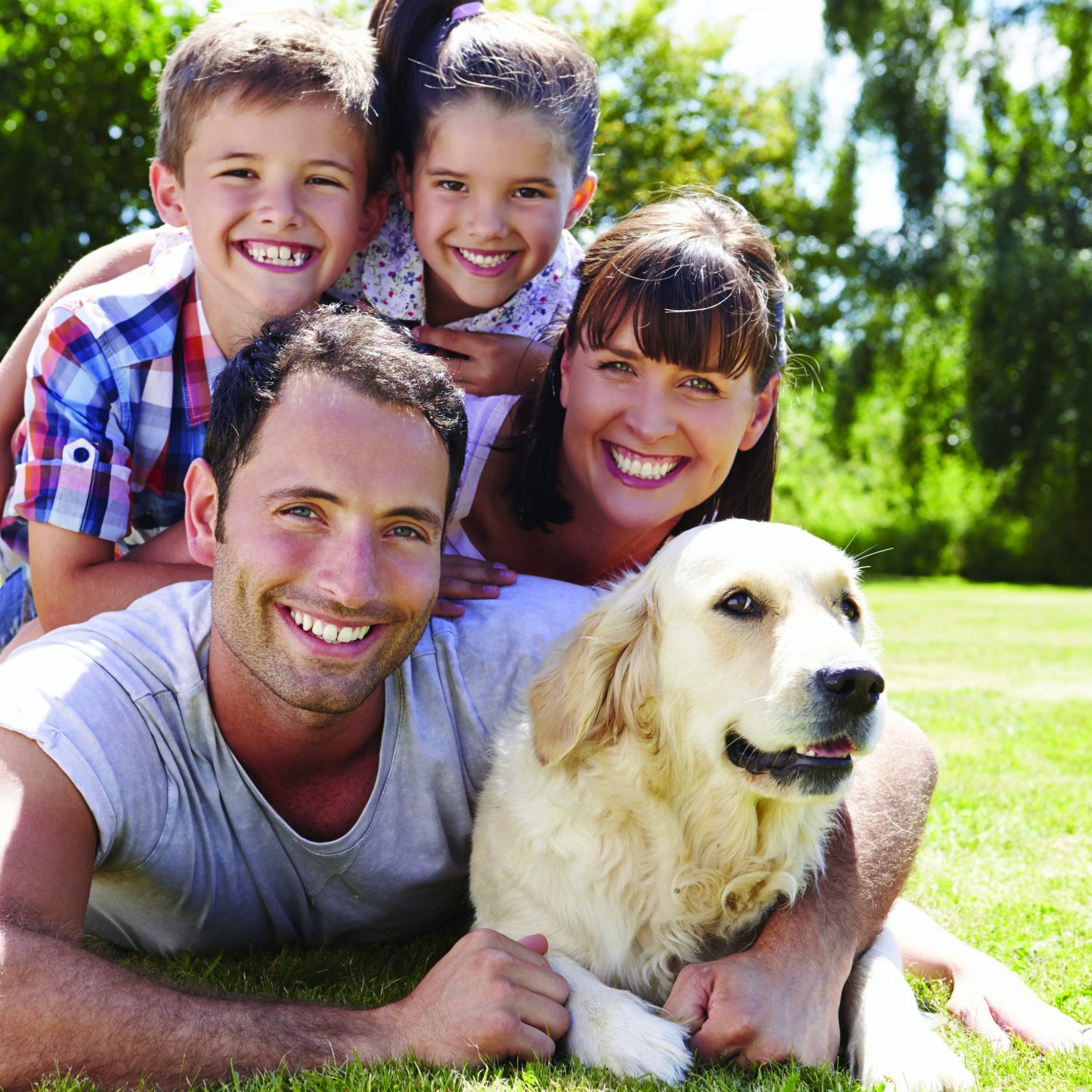 A couple with two children and a dog